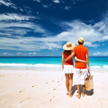 Couple relaxing on tropical beach clipart