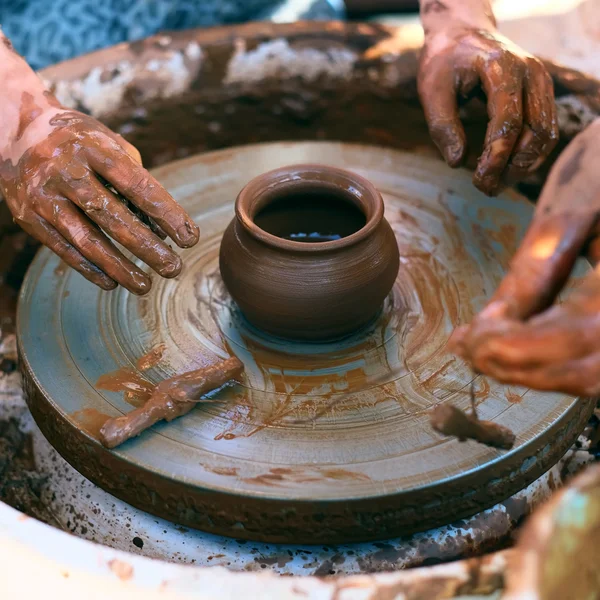 Potter guiding child hands — Stock Photo, Image