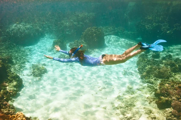 Woman with mask snorkeling