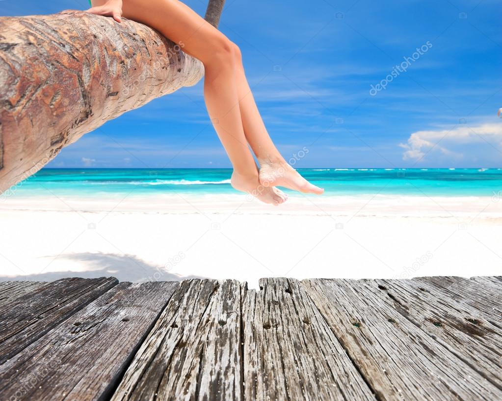 Woman on palm on beach