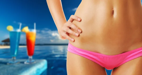 Woman at tropical swimming pool — Stock Photo, Image