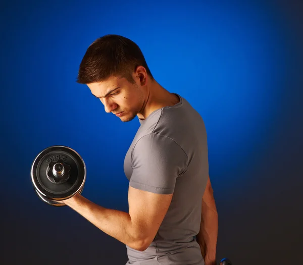 Man working out with dumbbell — Stock Photo, Image
