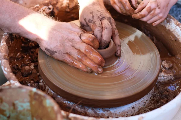 Manos trabajando en la rueda de cerámica — Foto de Stock