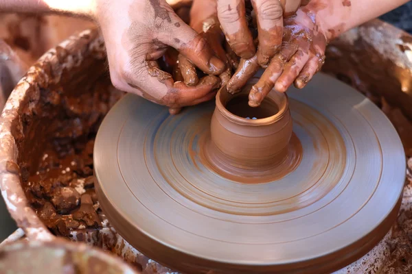 Hands working on pottery wheel — Stock Photo, Image