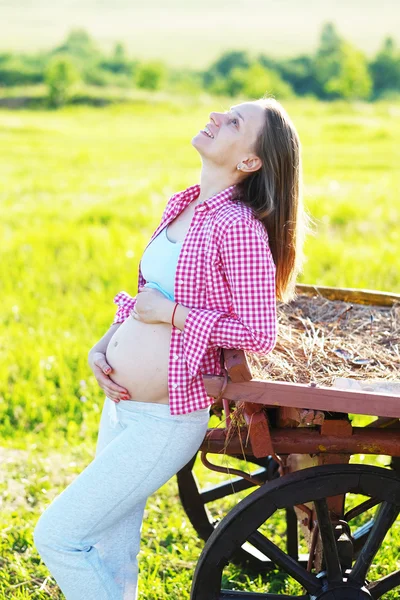Pregnant woman outdoors Stock Picture