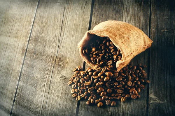 Coffee beans in bag on table — Stock Photo, Image