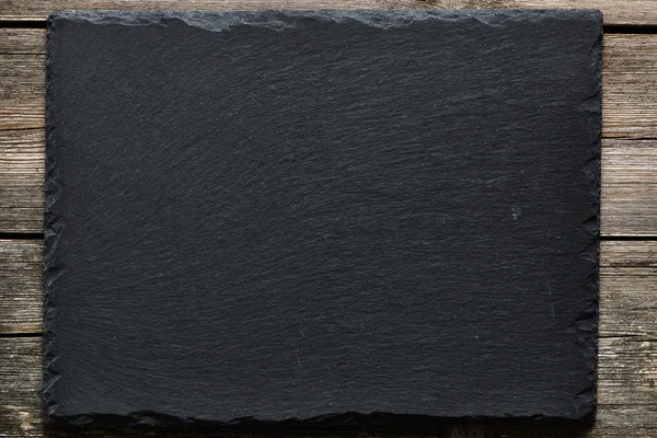 Slate on wooden  background — Stock Photo, Image