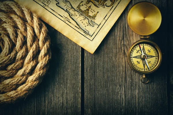 Antique compass and rope over old map — Stock Photo, Image