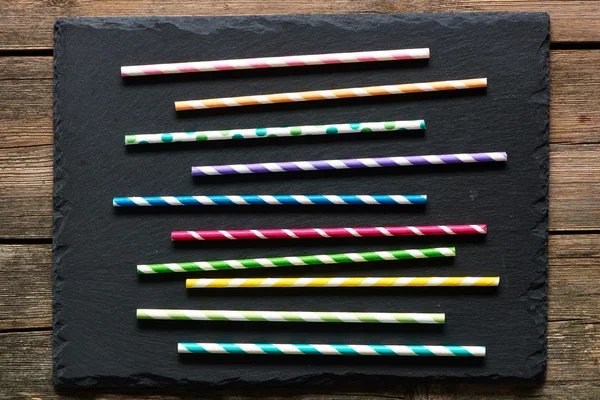 Drinking straws on slate — Stock Photo, Image