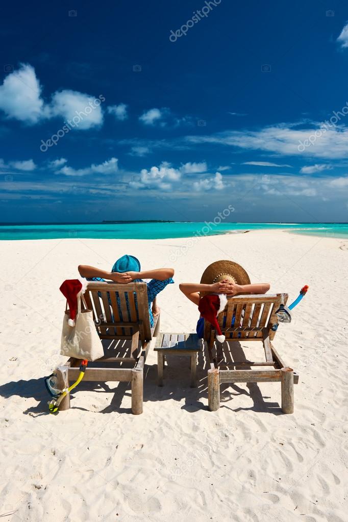 Couple relax on beach at christmas