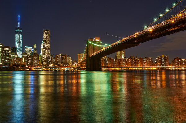 NEW YORK CITY - APRIL 2: Brooklyn Bridge with lower Manhattan skyline in New York City at night, USA, April 2 2014 in New York, US