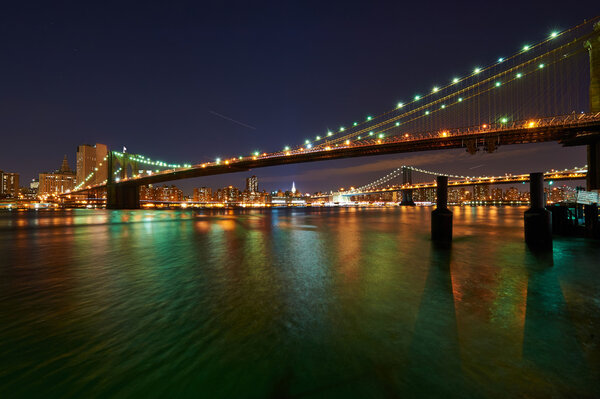 Brooklyn Bridge with lower Manhattan skyline in New York City at night