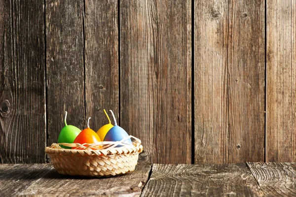 Easter candles on wooden table — Stock Photo, Image