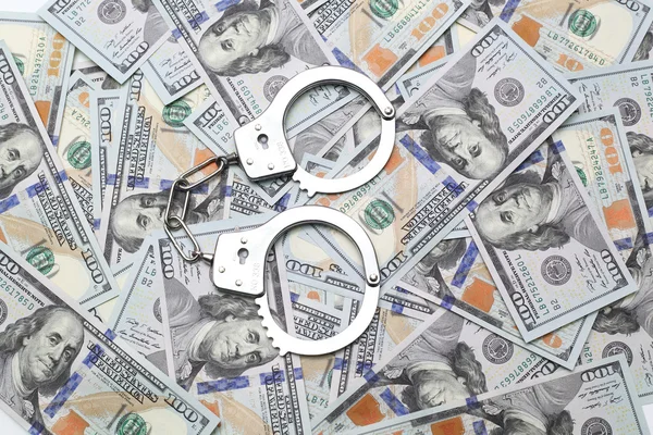 Handcuffs  on dollars — Stock Photo, Image