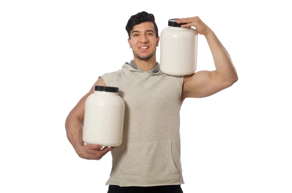 Muskulös man med protein burkar på vit — Stockfoto