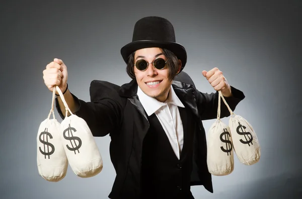 Homem engraçado com sacos de dólar — Fotografia de Stock