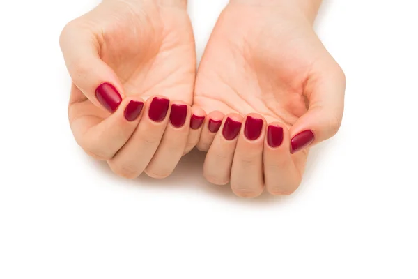 Mani donna con chiodo rosso isolato su bianco — Foto Stock