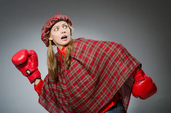 Woman in scottish clothing in boxing concept — Stock Photo, Image