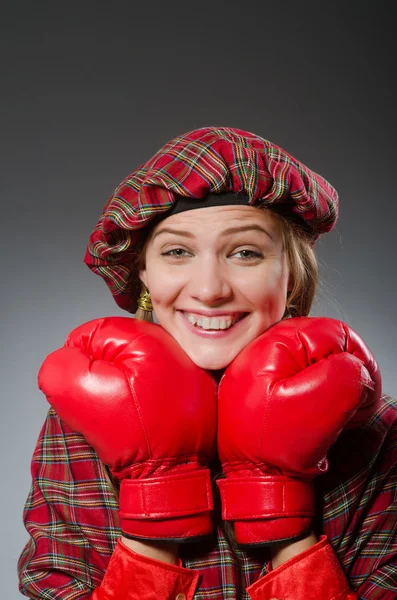 Woman in scottish clothing in boxing concept — Stock Photo, Image