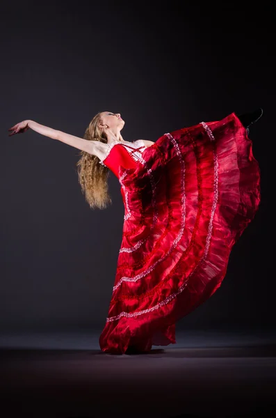 Young woman dancing in red dress — Stock Photo, Image