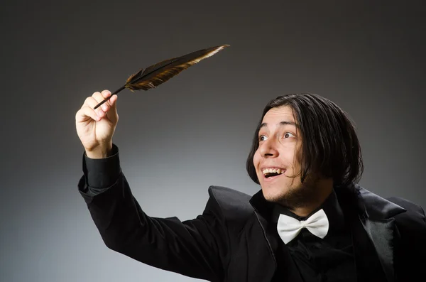 Young man with writing feather — Stock Photo, Image