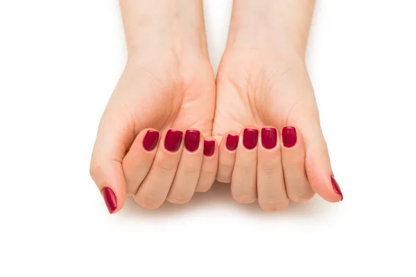 Γυναικεία χέρια με κόκκινο καρφί απομονώνονται σε λευκό — Φωτογραφία Αρχείου