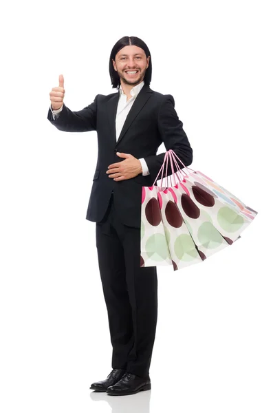 Fekete öltönyös férfi kezében műanyag zacskók elszigetelt fehér — Stock Fotó