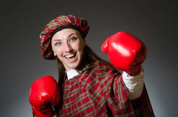 Woman in scottish clothing in boxing concept — Stock Photo, Image