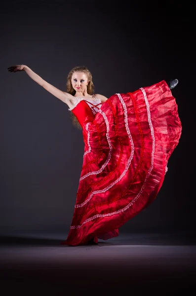 Young woman dancing in red dress — Stock Photo, Image