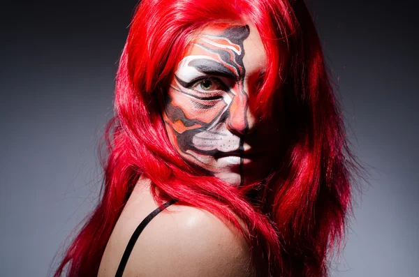 Woman with tiger face in halloween concept — Stock Photo, Image