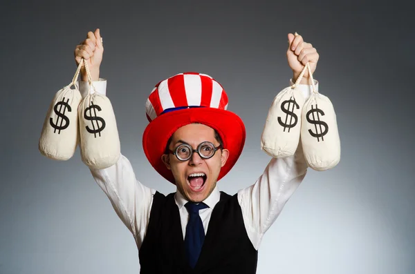 Hombre con sacos de dinero en dólares — Foto de Stock