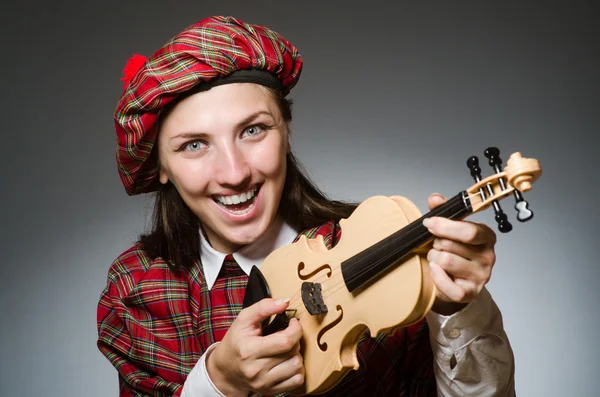 Mulher em roupas escocesas no conceito musical — Fotografia de Stock