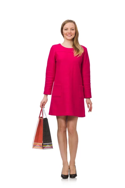 Shopper girl en vestido rosa sosteniendo bolsas de plástico aisladas en blanco — Foto de Stock