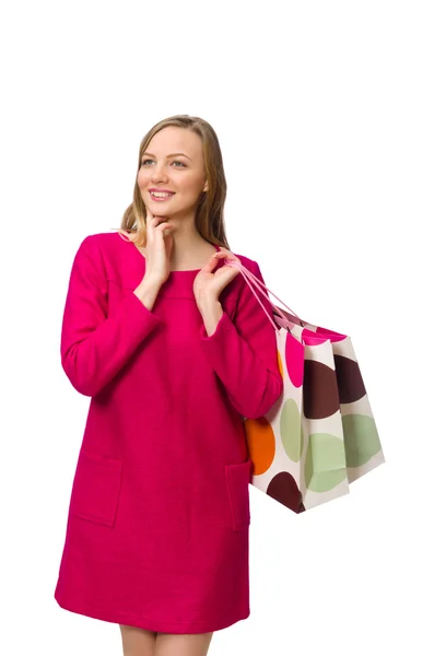 Shopper ragazza in abito rosa con sacchetti di plastica isolati su bianco — Foto Stock