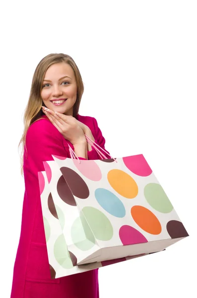 Shopper fille en robe rose tenant des sacs en plastique isolés sur blanc — Photo