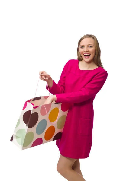 Shopper meisje in roze jurk houden van plastic zakken op wit wordt geïsoleerd — Stockfoto