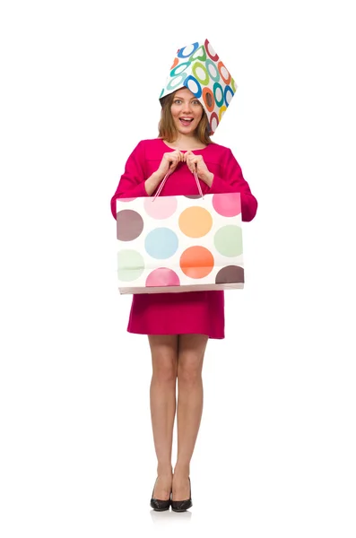 Shopper girl in pink dress holding plastic bags isolated on white — Stock Photo, Image