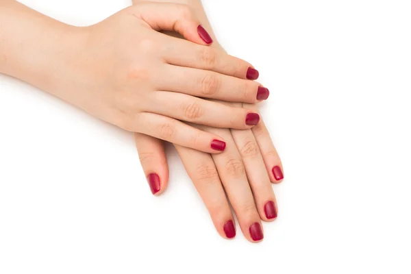 Beyaz çivili kırmızı tırnaklı kadın elleri — Stok fotoğraf