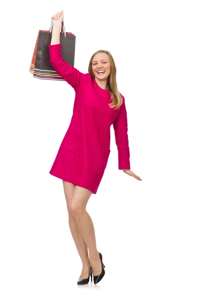 Shopper girl in pink dress holding plastic bags — Stock Photo, Image