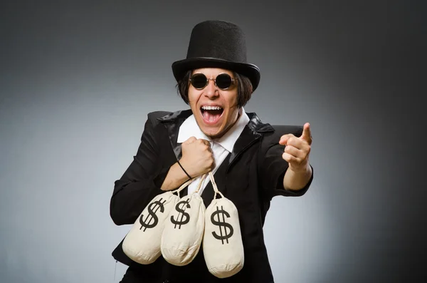 Homem engraçado com sacos de dólar — Fotografia de Stock