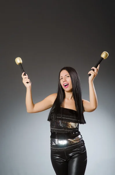 Karaoke kulübünde şarkı söyleyen genç bir kadın — Stok fotoğraf