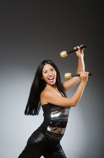 Young woman singing in karaoke club — Stock Photo, Image