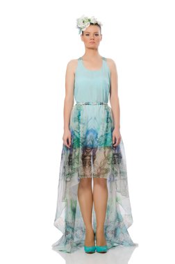 Beyaz üzerinde mavi çiçekli elbise giyen beyaz bir model.