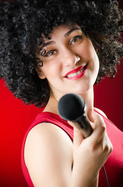 Frau mit Afro-Frisur singt im Karaoke — Stockfoto