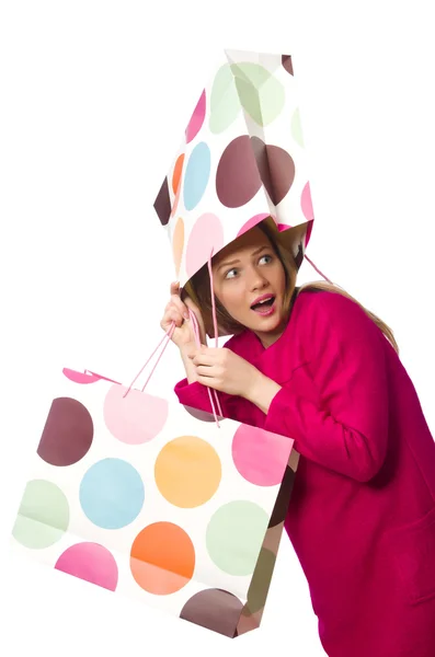 Bevásárló lány rózsaszín ruha gazdaság műanyag zacskók — Stock Fotó