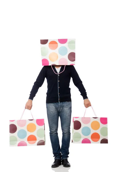 Joven sosteniendo bolsas de plástico aisladas en blanco —  Fotos de Stock