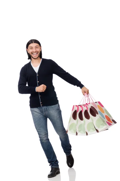 Giovane uomo in possesso di sacchetti di plastica isolati su bianco — Foto Stock