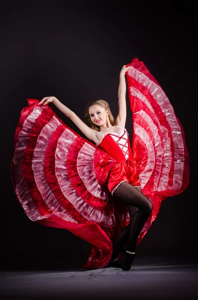 Young woman dancing in red dress — Stock Photo, Image