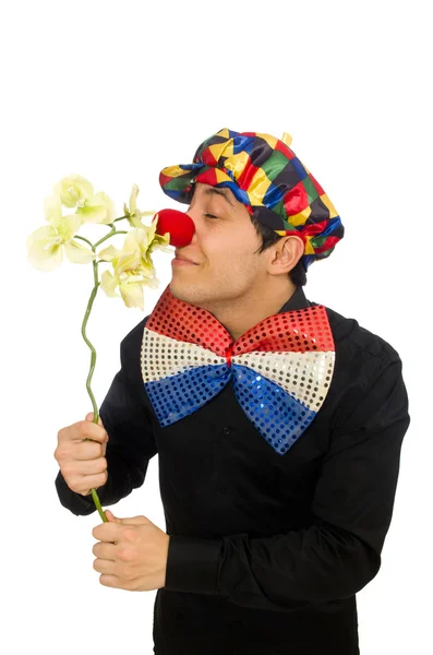 Lustiger Clown mit Blumen isoliert auf weiß — Stockfoto