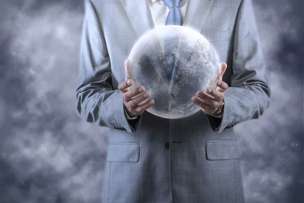 Businessman holding earth in global concept — Stock Photo, Image